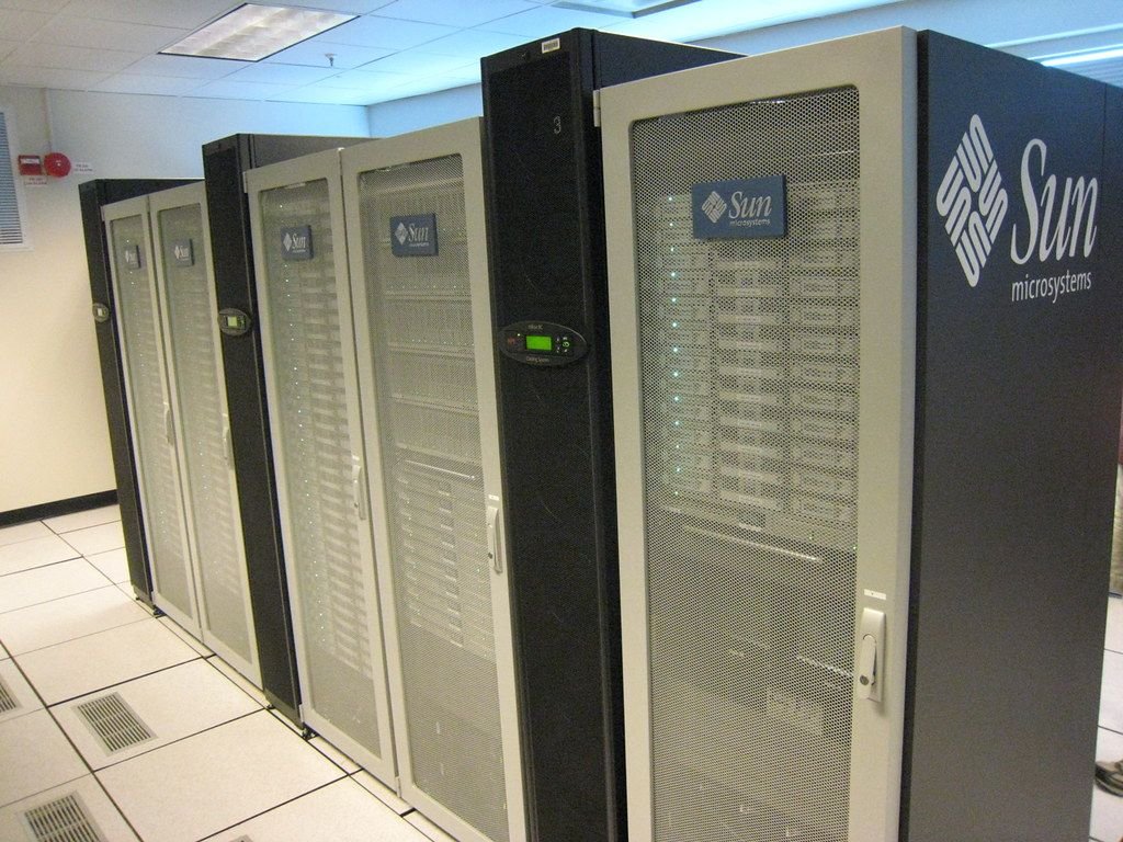 Laptop connected to a server rack for cloud services